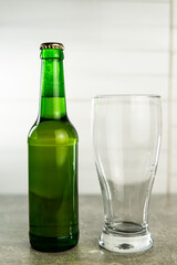 a bottle of beer and an empty glass