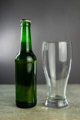 a bottle of beer and an empty glass
