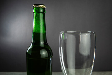 a bottle of beer and an empty glass