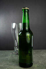 a bottle of beer and an empty glass