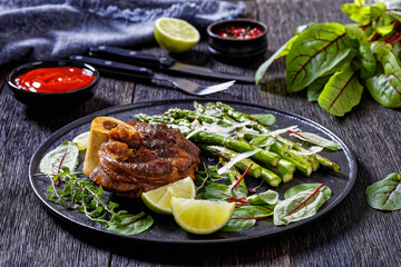 braised osso buco with grilled asparagus, top view