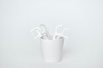 white mock up of toothpicks made of dental floss and plastic on white background