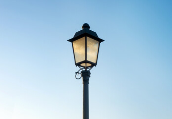 Fototapeta na wymiar photo of an old styled street lamp against a clear blue sky
