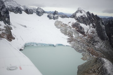 the photo captures the moment of takeoff and flight by plane over Ushuaia — a city and port in...