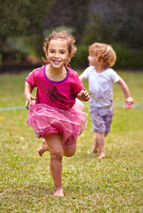 Fototapeta na wymiar Running as fast as can be. Shot of a little girl running with her little brother outside.
