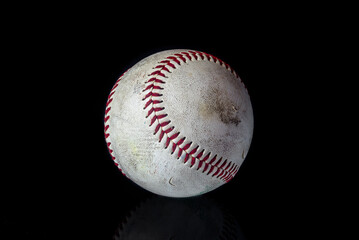 Baseball ball on black background. American traditional sports game.