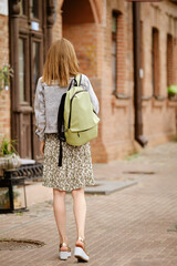 Tourist woman in old town, rear view, full length