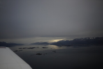 the photo captures the moment of takeoff and flight by plane over Ushuaia — a city and port in southern Argentina.