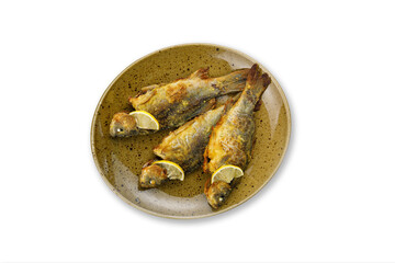 cooked fish on a plate on a white background
