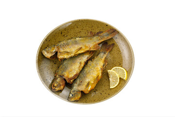 cooked fish on a plate on a white background

