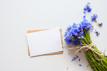 Postcard with empty text, gift and flowers