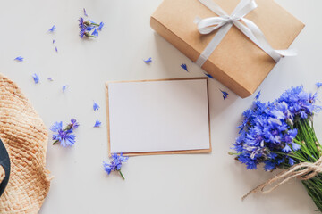 Postcard with empty text, gift and flowers