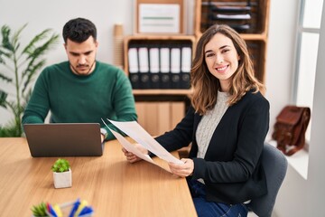 Man and woman business workers using laptop working at office