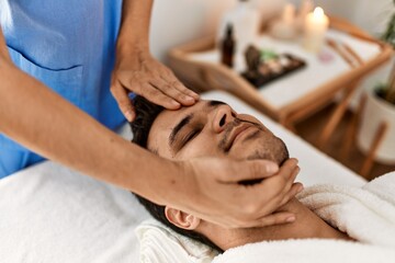 Fototapeta na wymiar Man smiling happy reciving head massage at beauty center.