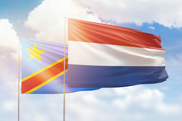 Sunny blue sky and flags of netherlands and dr congo