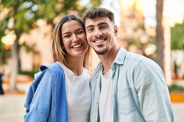 Obraz premium Young man and woman couple smiling confident standing together at street