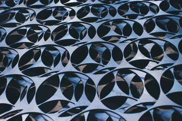 Steel sheets with the same pattern cut out on a black background