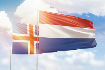 Sunny blue sky and flags of netherlands and iceland