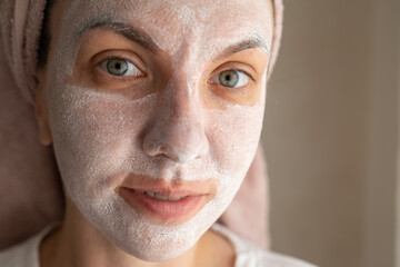 girl in a cosmetic mask on her face. woman, cream on her face. Attractive girl with moisturizing...