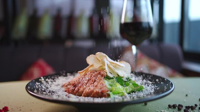 fresh caesar salad with lettuce, grilled chicken, crusty toast, red wine glass