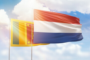 Sunny blue sky and flags of netherlands and sri lanka