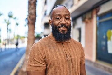 Young african american man smiling confident standing at street