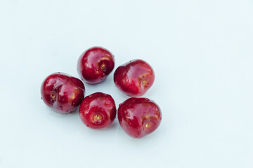 Sweet red cherry berries with drops isolated on white background