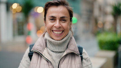 Middle age hispanic woman smiling confident standing at street