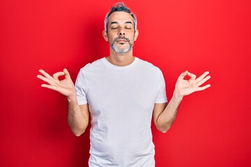 Handsome middle age man with grey hair wearing casual white t shirt relax and smiling with eyes...