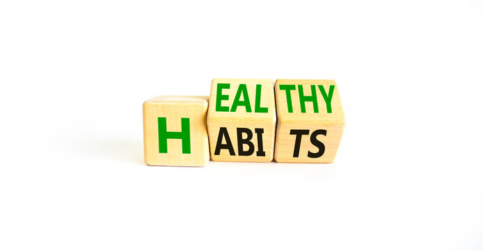 Healthy habits symbol. Concept words Healthy habits on wooden cubes. Beautiful white table white background. Medical and healthy habits concept. Copy space.