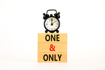 One and only symbol. Concept words One and only on wooden blocks on a beautiful white table white background. Black alarm clock. Business, motivational One and only concept. Copy space.