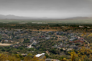 Rural town and mountains with gray fog sky