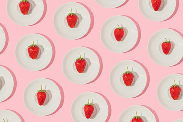 Summer creative pattern with strawberry on small plate on pastel pink background. 70s, 80s or 90s retro fashion aesthetic fruit idea. Minimal summer romantic idea.
