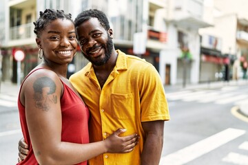 Young afircan american couple smiling happy and hugging at the city.