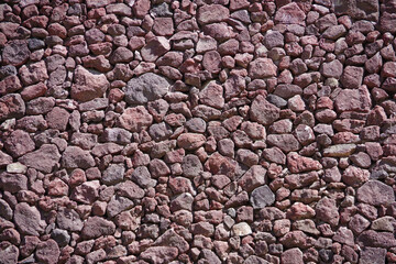 Small rough red gravel stones covering the ground