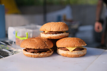Homemade delicious three mini burgers served with salad, sauce and french fries