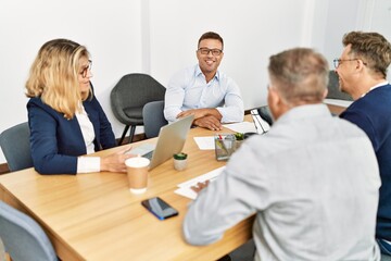 Group of middle age business workers working at the office.