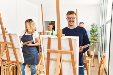 Group of middle age paint students drawing at art studio.