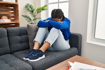 Young hispanic woman crying having psychology session at clinic