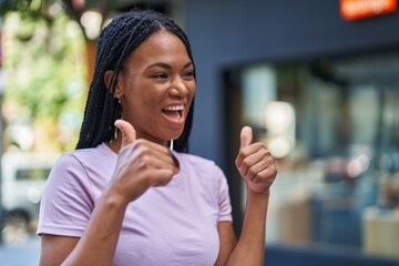 African american woman smiling confident doing ok sign with thumbs up at street