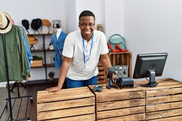 Young african man working as shop assistance at retail shop