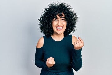 Young middle east woman wearing casual clothes celebrating surprised and amazed for success with arms raised and eyes closed