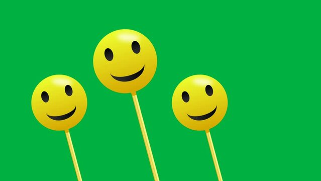 Smile emoji in swinging motion direction isolated on green screen.
