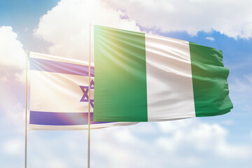 Sunny blue sky and flags of nigeria and israel