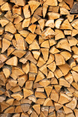 Firewood chopped and stacked in a firewood shed. Preparation for the winter heating in the stove....