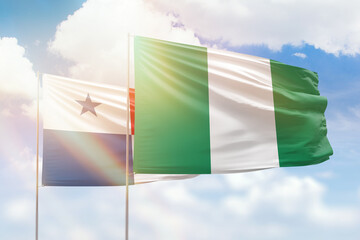 Sunny blue sky and flags of nigeria and panama