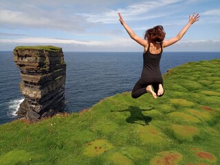 Zero gravity Girl cliff jumping Dun Briste Downpatrick Head Ireland