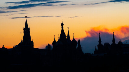 Black silhouette of Cathedral of Vasily the Blessed, Spasskaya Tower and Kremlin. Sunset sky. High quality photo