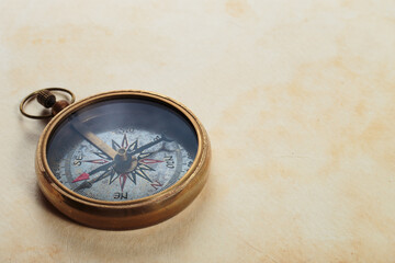 Fototapeta na wymiar Antique compass on old paper background