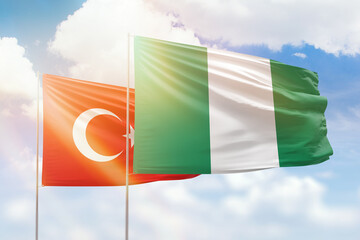 Sunny blue sky and flags of nigeria and turkey